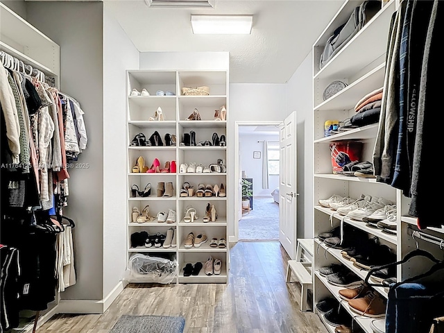 spacious closet with visible vents and wood finished floors