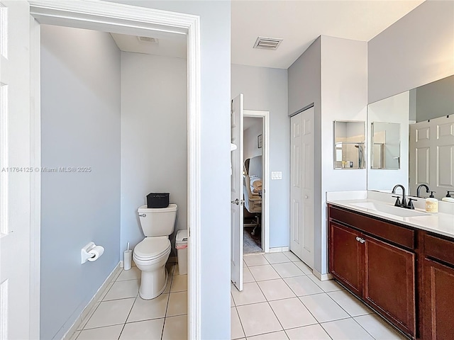 bathroom with toilet, visible vents, tile patterned floors, and vanity