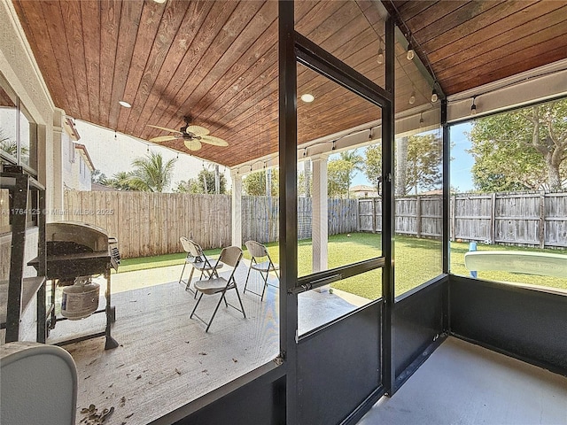 unfurnished sunroom with ceiling fan