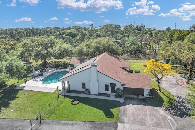 drone / aerial view featuring a wooded view