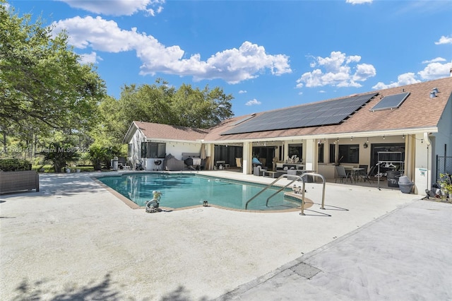 outdoor pool featuring outdoor dining area and a patio area