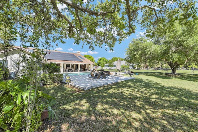 view of yard with an outdoor pool and a patio area