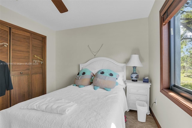 bedroom with baseboards, a closet, and a ceiling fan