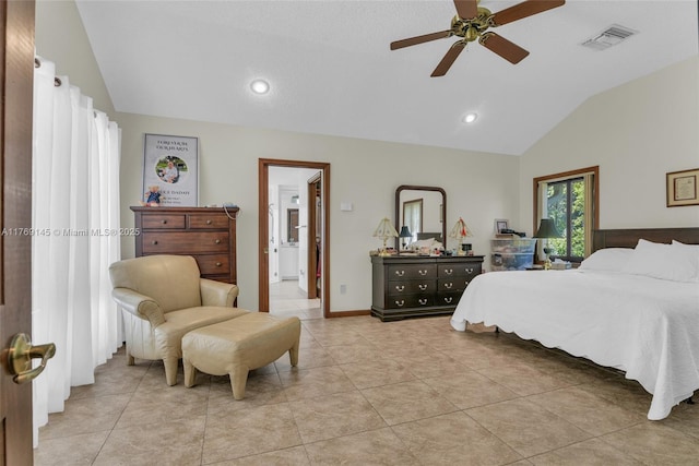 bedroom featuring light tile patterned flooring, ensuite bathroom, visible vents, and vaulted ceiling