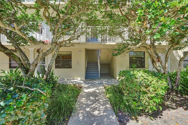 3515 Village Blvd Unit 105, West Palm Beach, FL 33409 - exterior space featuring stucco siding and a balcony