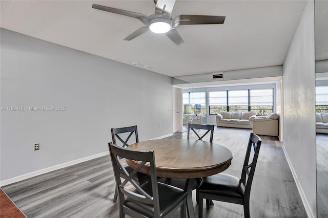 dining area with ceiling fan, wood finished floors, and a wealth of natural light