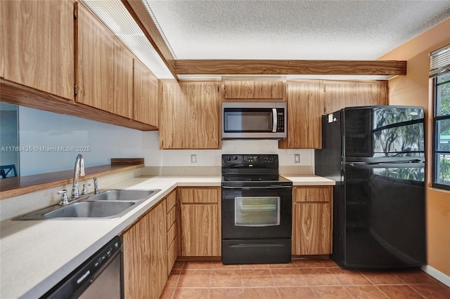 kitchen with a sink, light tile patterned flooring, black appliances, and light countertops