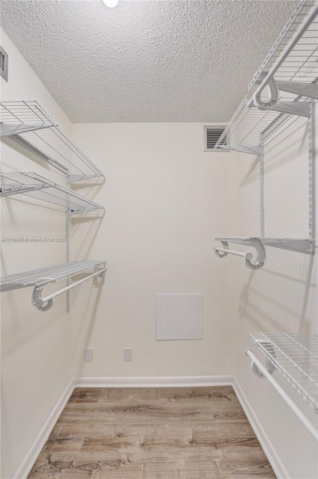 3515 Village Blvd Unit 105, West Palm Beach, FL 33409 - walk in closet featuring light wood-style flooring and visible vents