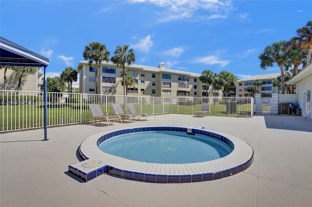 view of pool featuring fence, a swimming pool, and a patio