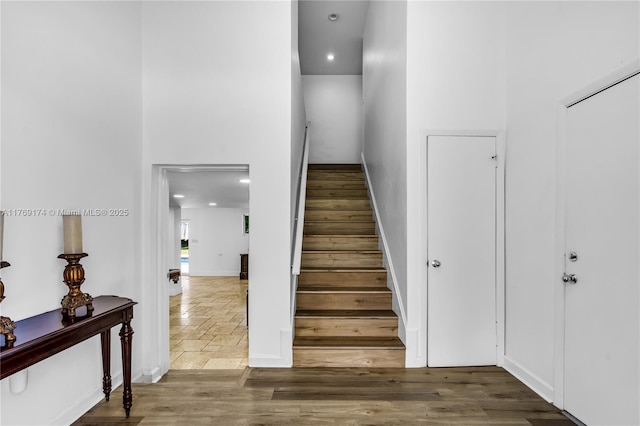 6300 SW Mitchell Dr, Coral Gables, FL 33158 - stairs featuring baseboards, a high ceiling, and wood finished floors