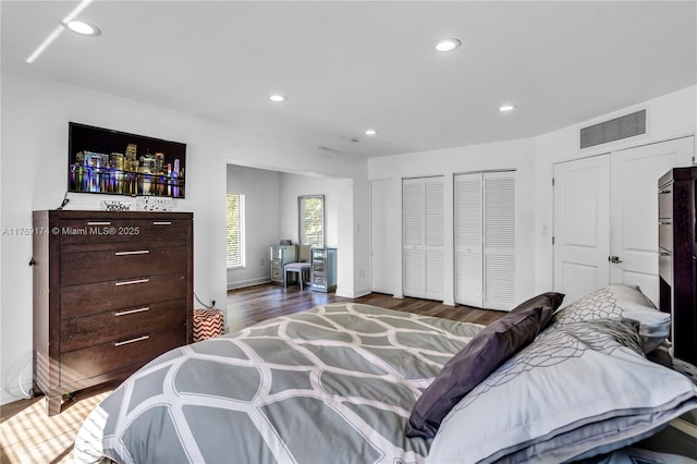 6300 SW Mitchell Dr, Coral Gables, FL 33158 - bedroom with visible vents, wood finished floors, two closets, and recessed lighting