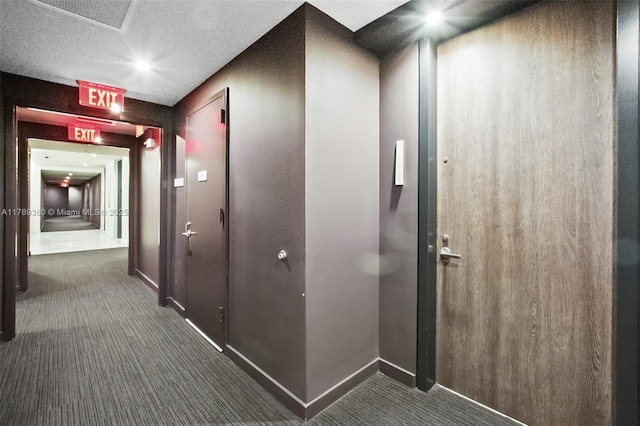 68 SE 6th St Unit 805, Miami, FL 33131 - hallway featuring baseboards, dark carpet, a textured ceiling, and visible vents