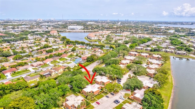 drone / aerial view with a residential view and a water view