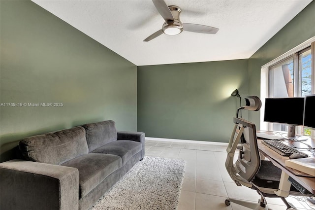 office area with light tile patterned flooring, ceiling fan, a textured ceiling, and baseboards