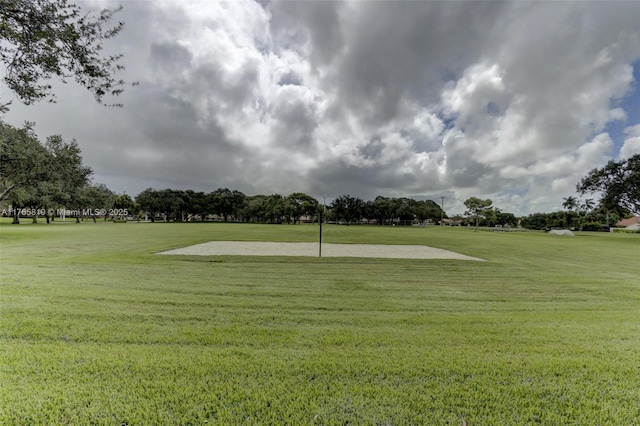 view of property's community with a lawn
