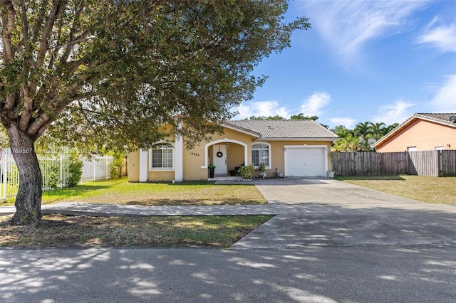 14930 SW 178th Ter, Miami, FL 33187 - view of front of property featuring driveway, stucco siding, fence, and a front lawn