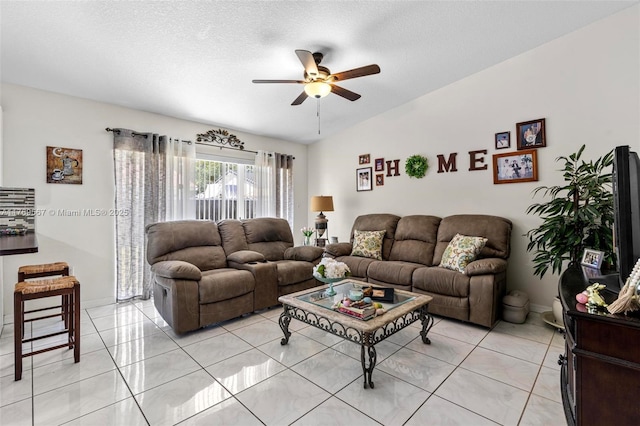 14930 SW 178th Ter, Miami, FL 33187 - living room with a ceiling fan, light tile patterned floors, vaulted ceiling, and a textured ceiling
