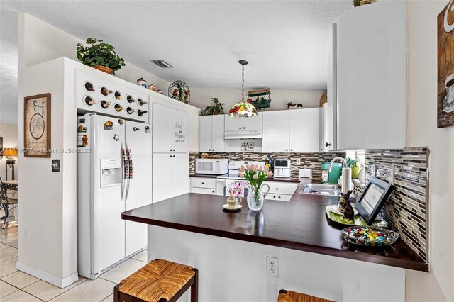 14930 SW 178th Ter, Miami, FL 33187 - kitchen featuring white appliances, dark countertops, under cabinet range hood, a sink, and backsplash