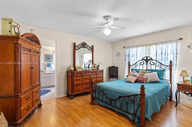 14930 SW 178th Ter, Miami, FL 33187 - bedroom with ensuite bath, a textured ceiling, ceiling fan, and light wood-type flooring