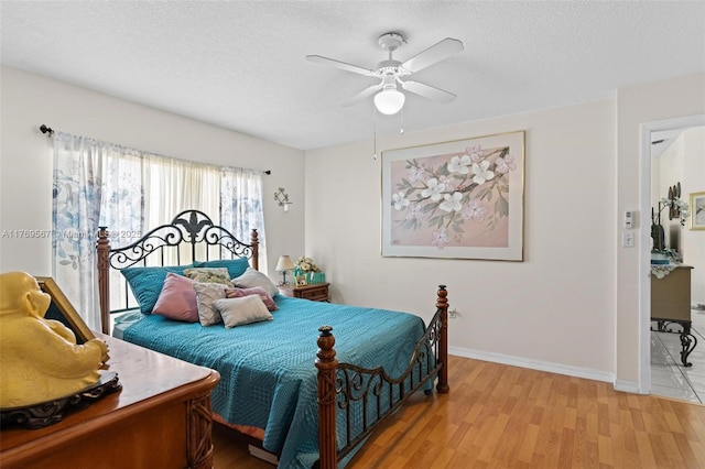14930 SW 178th Ter, Miami, FL 33187 - bedroom featuring a ceiling fan, baseboards, light wood-style floors, and a textured ceiling