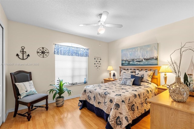 14930 SW 178th Ter, Miami, FL 33187 - bedroom with baseboards, a ceiling fan, wood finished floors, and a textured ceiling
