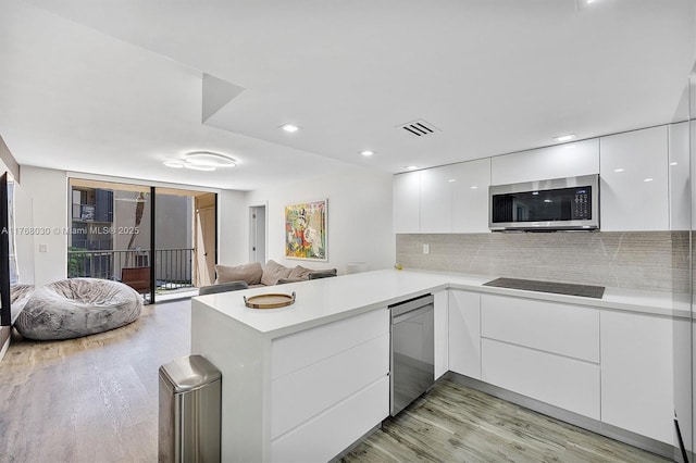 14601 N Kendall Dr Unit 206K, Miami, FL 33186 - kitchen featuring stainless steel appliances, modern cabinets, white cabinetry, a peninsula, and light wood-style flooring