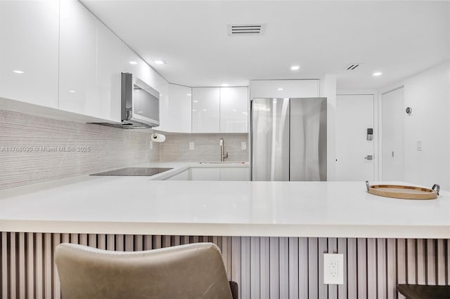 14601 N Kendall Dr Unit 206K, Miami, FL 33186 - kitchen with white cabinetry, stainless steel appliances, a sink, visible vents, and modern cabinets
