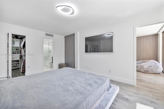 14601 N Kendall Dr Unit 206K, Miami, FL 33186 - bedroom with baseboards, visible vents, wood finished floors, and a walk in closet