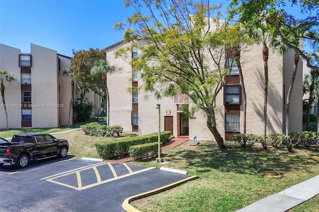 14601 N Kendall Dr Unit 206K, Miami, FL 33186 - view of building exterior featuring uncovered parking