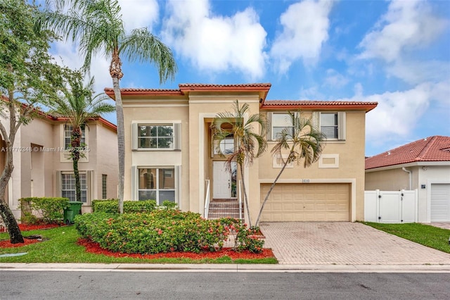16103 Opal Creek Dr, Weston, FL 33331 - mediterranean / spanish-style house featuring stucco siding, decorative driveway, a garage, and a tile roof