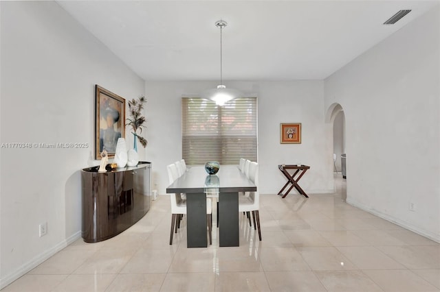 16103 Opal Creek Dr, Weston, FL 33331 - dining space with arched walkways, light tile patterned floors, and baseboards
