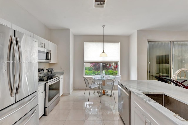 16103 Opal Creek Dr, Weston, FL 33331 - kitchen with appliances with stainless steel finishes, a sink, white cabinetry, pendant lighting, and light stone countertops