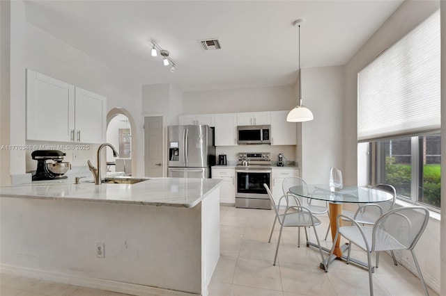 16103 Opal Creek Dr, Weston, FL 33331 - kitchen featuring appliances with stainless steel finishes, a sink, a peninsula, and white cabinets
