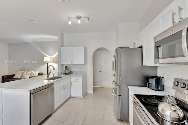 16103 Opal Creek Dr, Weston, FL 33331 - kitchen with stainless steel appliances, a sink, a peninsula, and white cabinetry