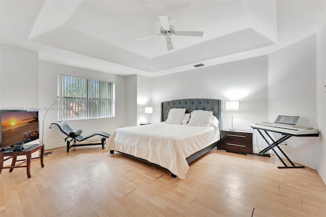 16103 Opal Creek Dr, Weston, FL 33331 - bedroom with a tray ceiling, light wood-style flooring, and a ceiling fan