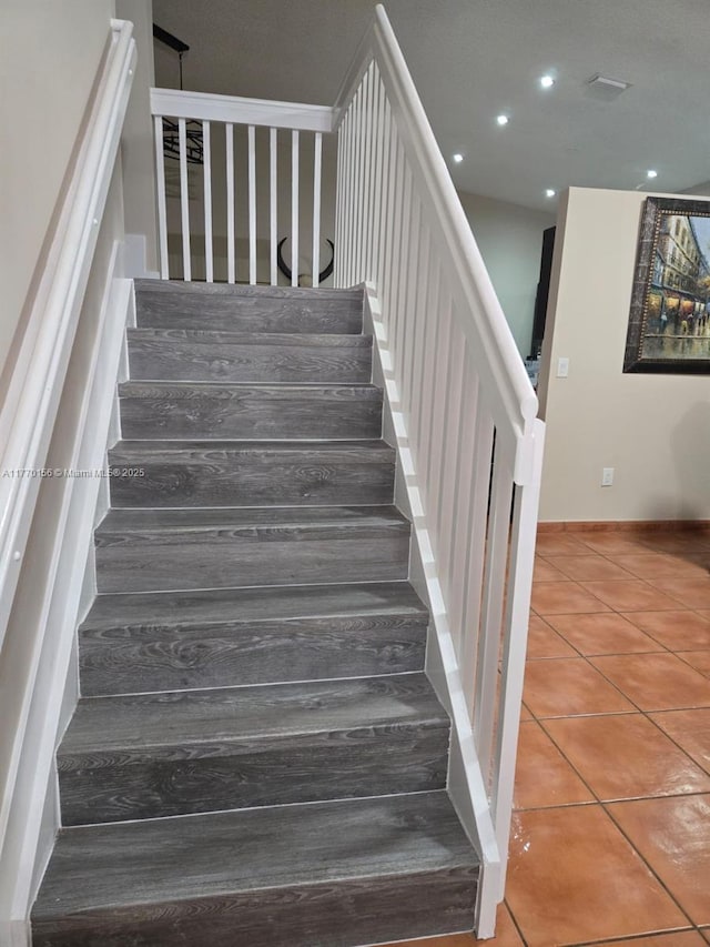 stairs with recessed lighting and tile patterned flooring