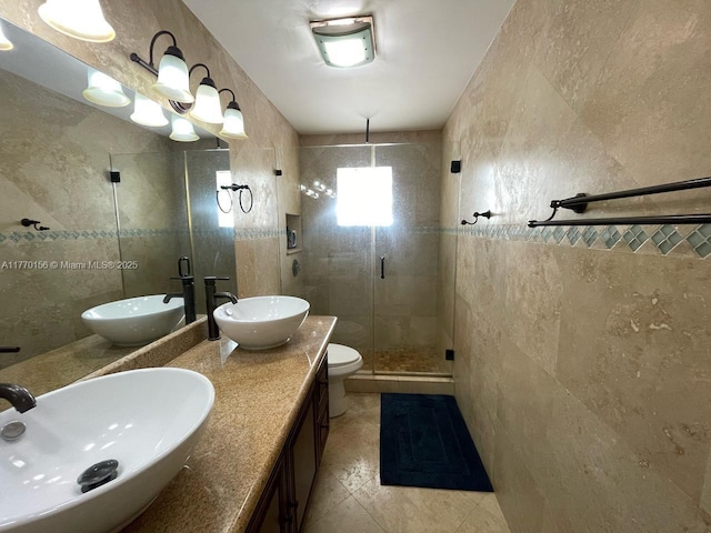 bathroom featuring tile walls, a sink, and a shower stall