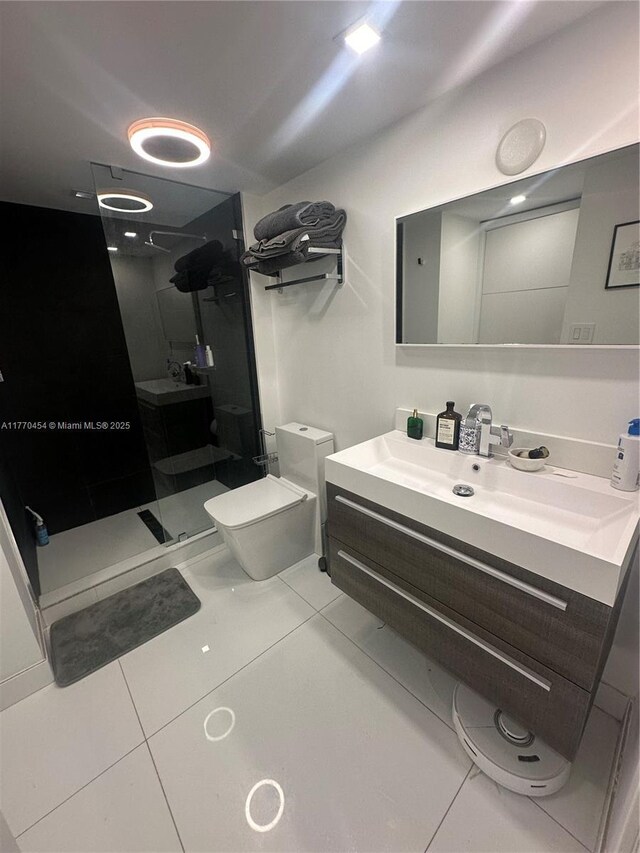 20225 NE 34th St Unit 1022, Aventura, FL 33180 - full bathroom with toilet, vanity, a stall shower, and tile patterned flooring