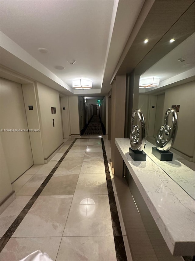 20225 NE 34th St Unit 1022, Aventura, FL 33180 - hallway featuring a tray ceiling and baseboards