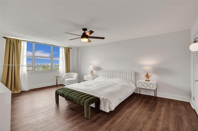 bedroom featuring baseboards, ceiling fan, and wood finished floors