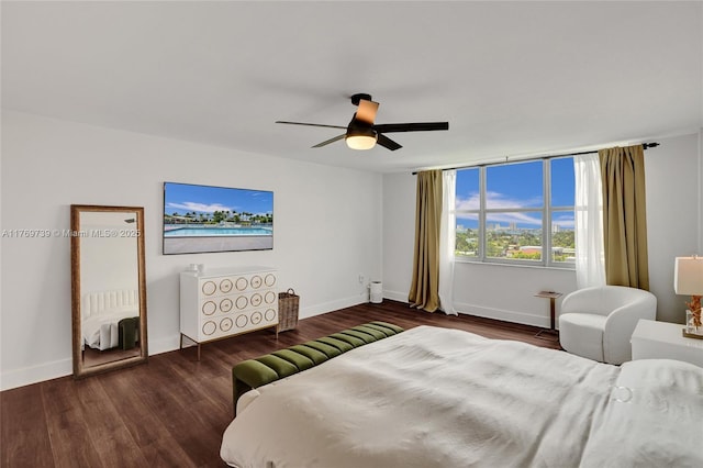 bedroom featuring baseboards, wood finished floors, and a ceiling fan