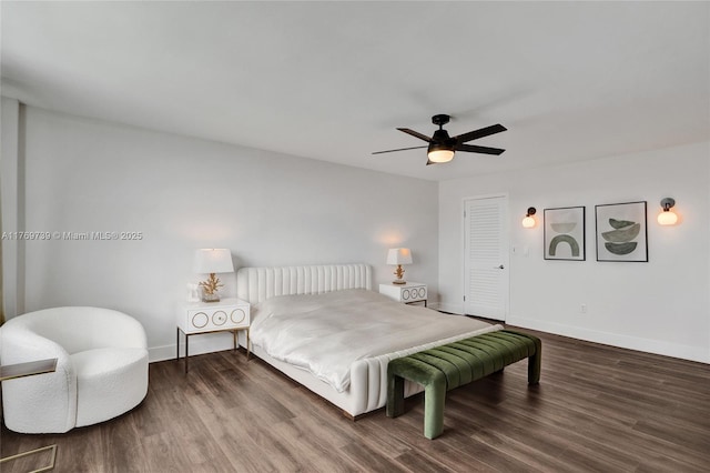 bedroom featuring baseboards, wood finished floors, and a ceiling fan