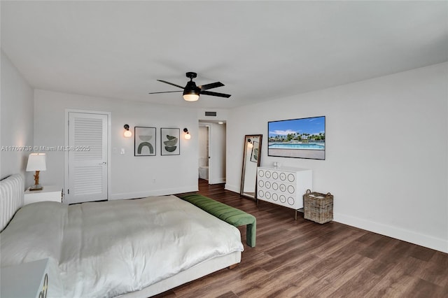 bedroom featuring baseboards, visible vents, wood finished floors, and a ceiling fan