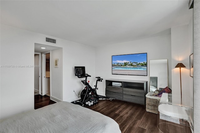 bedroom with dark wood finished floors, baseboards, and visible vents