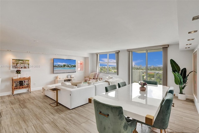 dining space with baseboards and wood finish floors