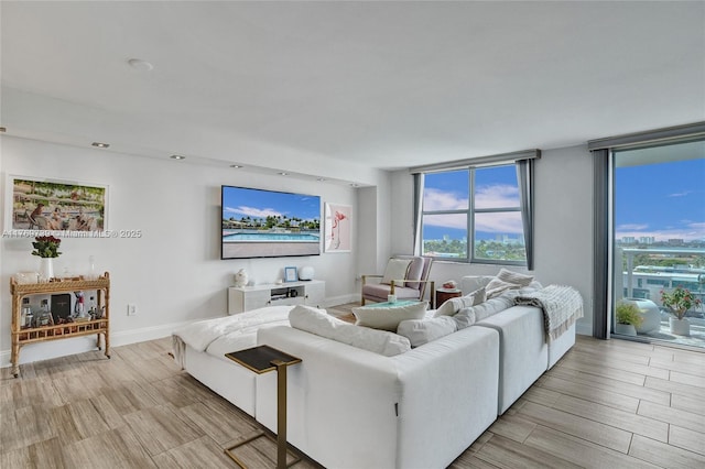 living room featuring baseboards and light wood-style flooring