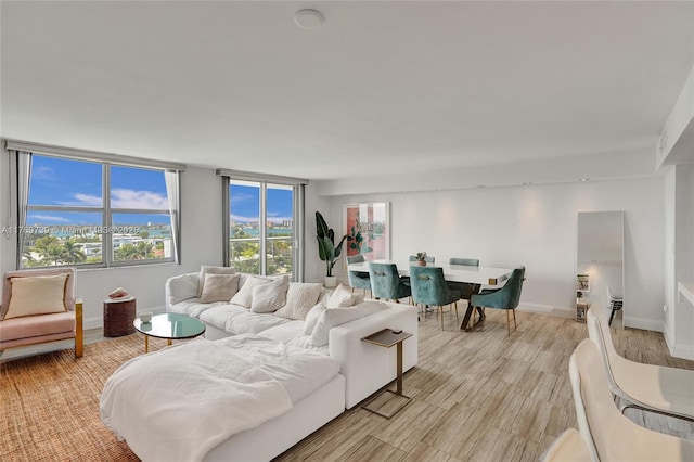 living room featuring light wood finished floors and baseboards