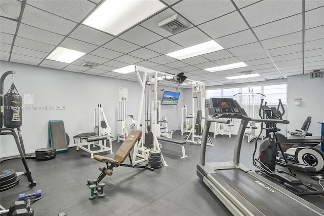 exercise room featuring visible vents and a paneled ceiling