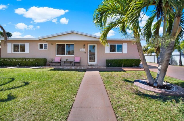 30328 SW 158th Pl, Homestead, FL 33033 - ranch-style home with a front yard, fence, and stucco siding