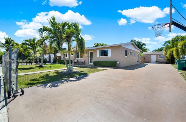30328 SW 158th Pl, Homestead, FL 33033 - view of front facade with a front yard, an outbuilding, driveway, and stucco siding
